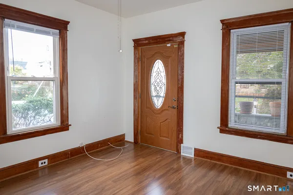 a view of a livingroom with wooden floor and a window