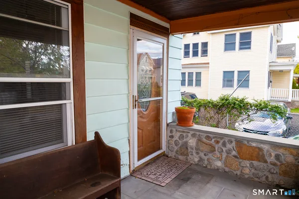 a view of front door of house with outdoor seating
