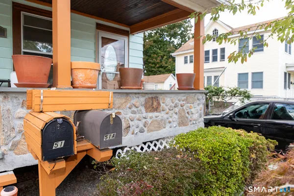 a front view of a house with outdoor seating