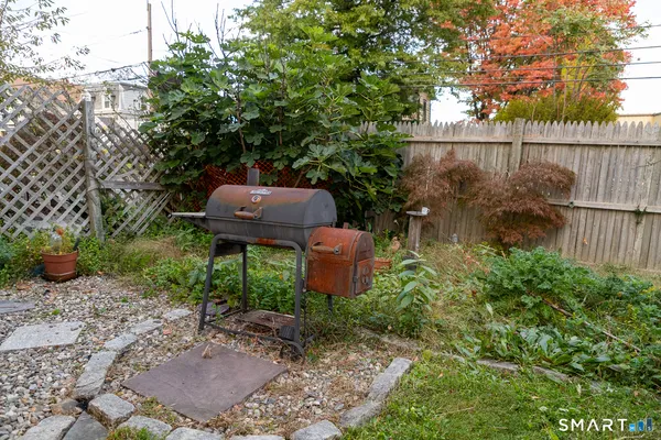 a view of a backyard with plants and outdoor seating