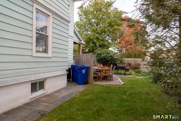 a backyard of a house with outdoor seating
