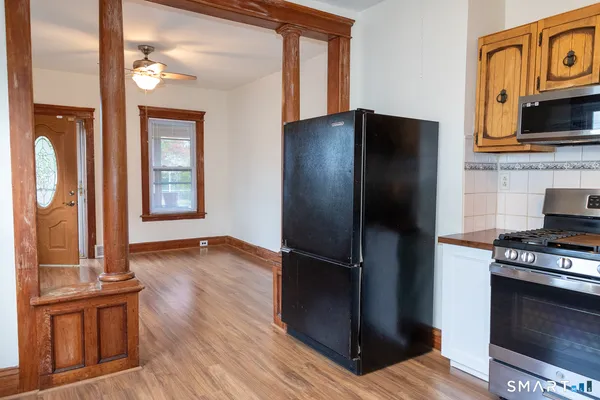 a kitchen with granite countertop stainless steel appliances and wooden cabinets