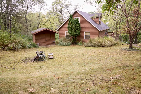 a backyard of a house with table and chairs