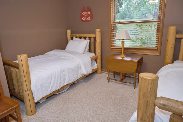 a view of a hallway with wooden floor and a flat screen tv
