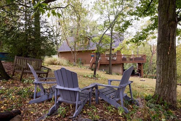 a view of a balcony with chairs and wooden floor