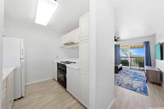 a kitchen with stainless steel appliances granite countertop a refrigerator and a stove