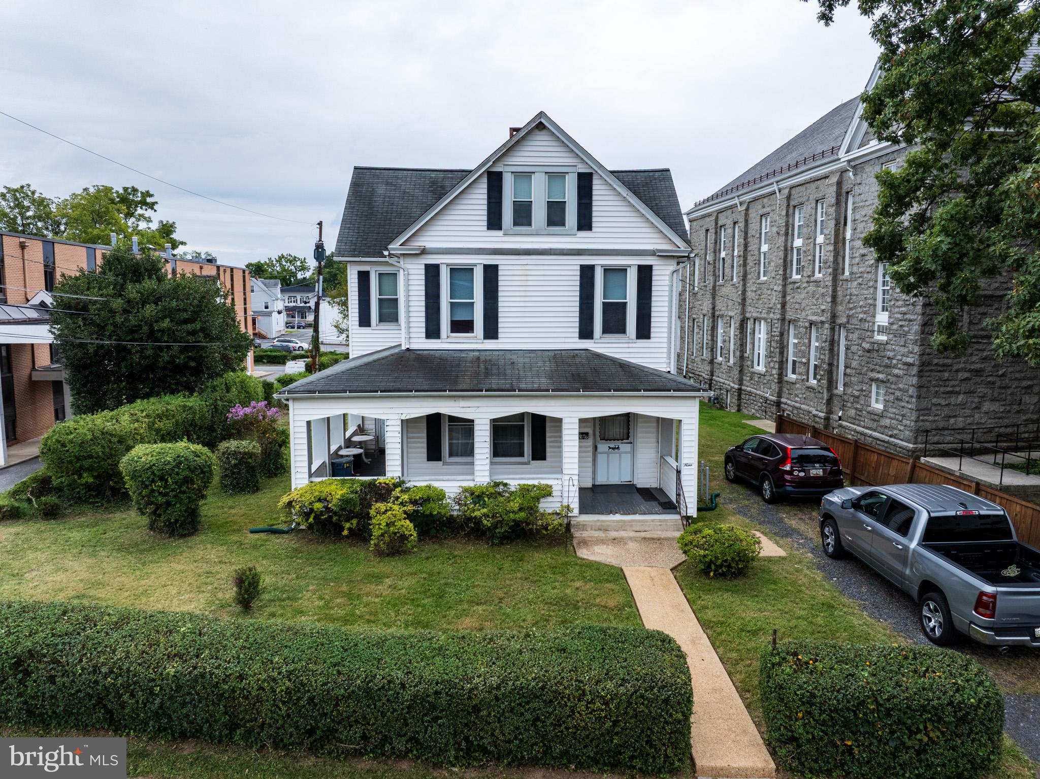 a front view of a house with a garden and plants