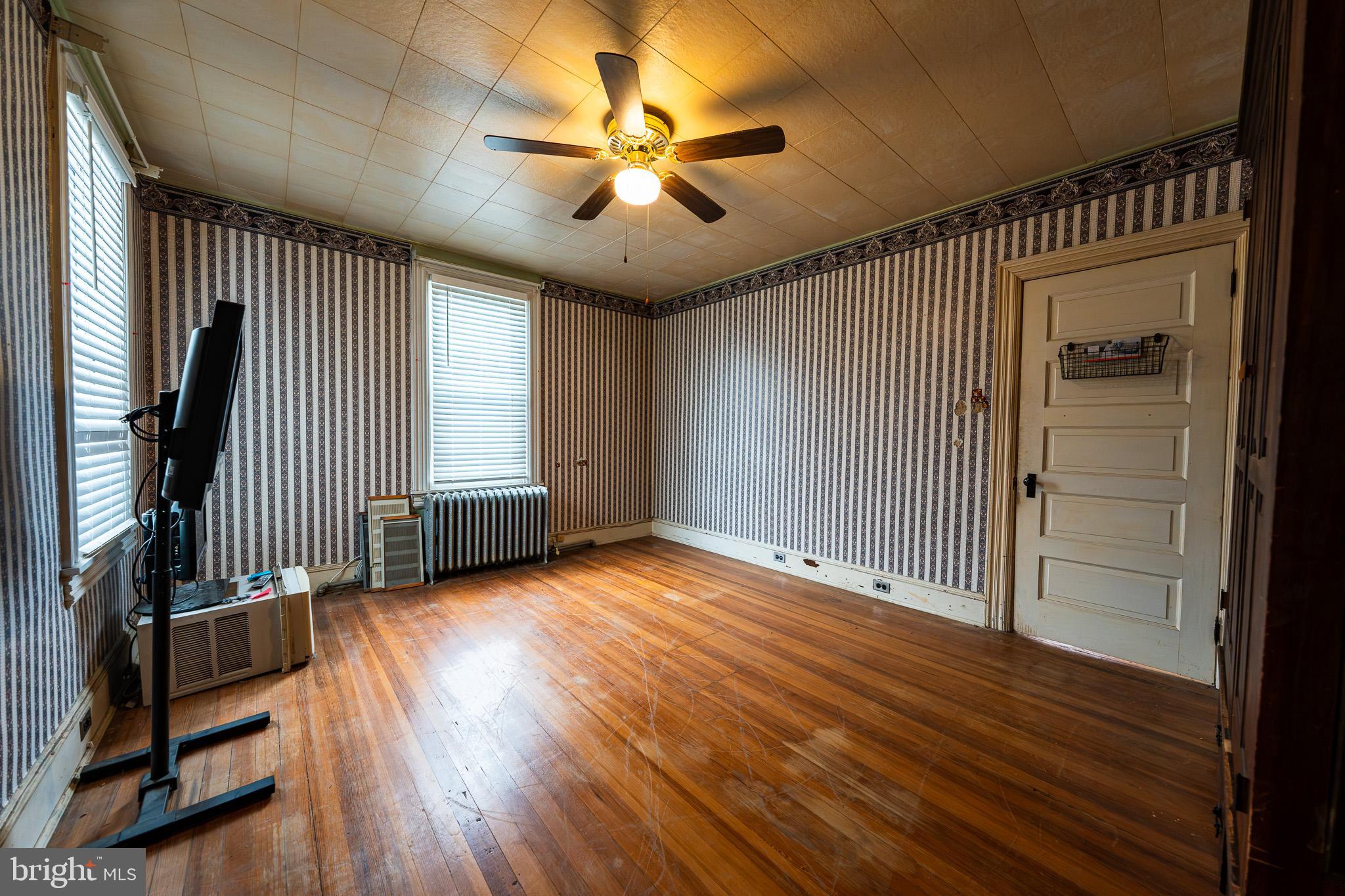 9 Church Lane Baltimore, MD 21208 - Photo 23 of 31 an empty room with wooden floor and windows