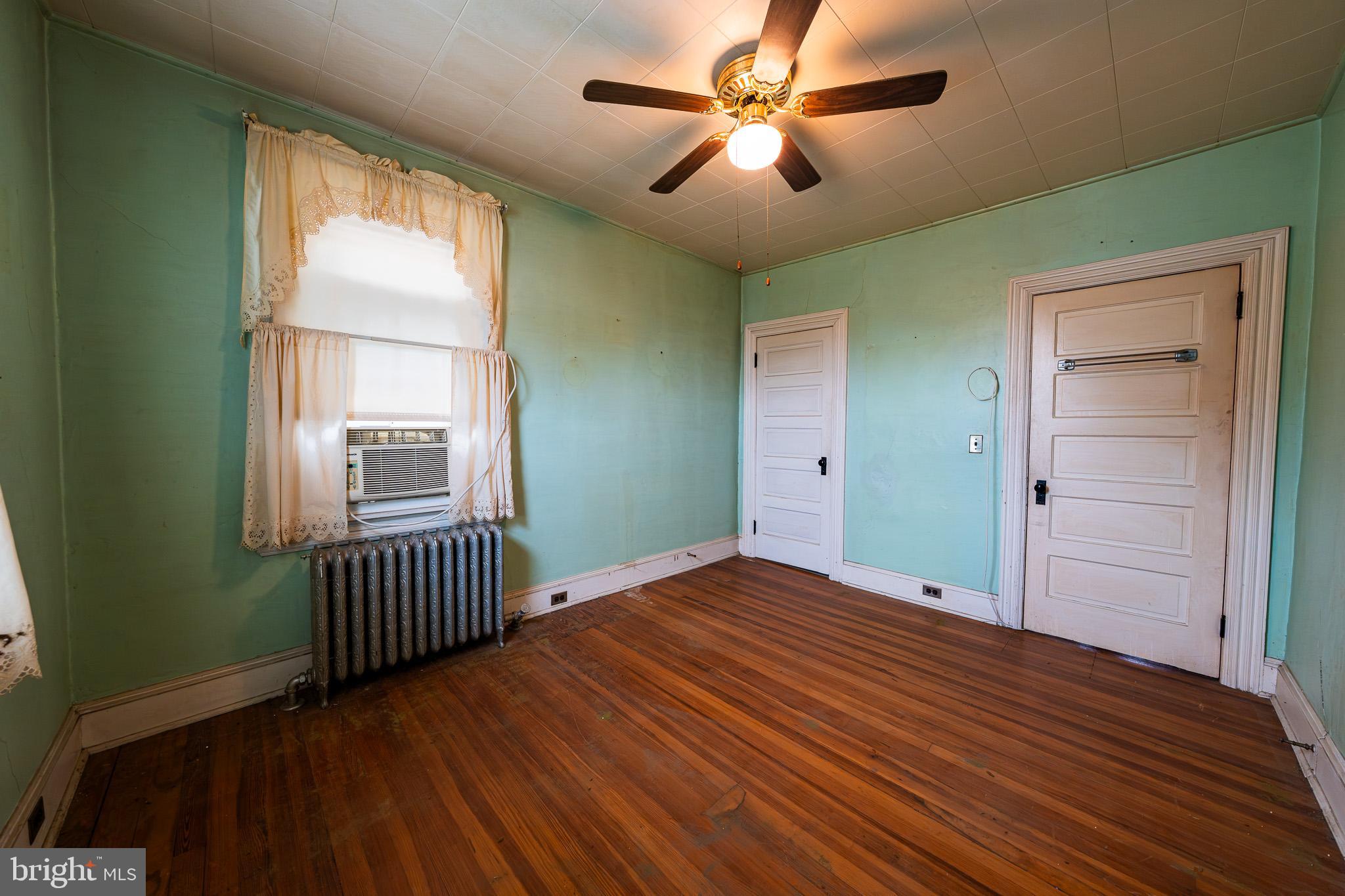 9 Church Lane Baltimore, MD 21208 - Photo 26 of 31 wooden floor in an empty room with a window