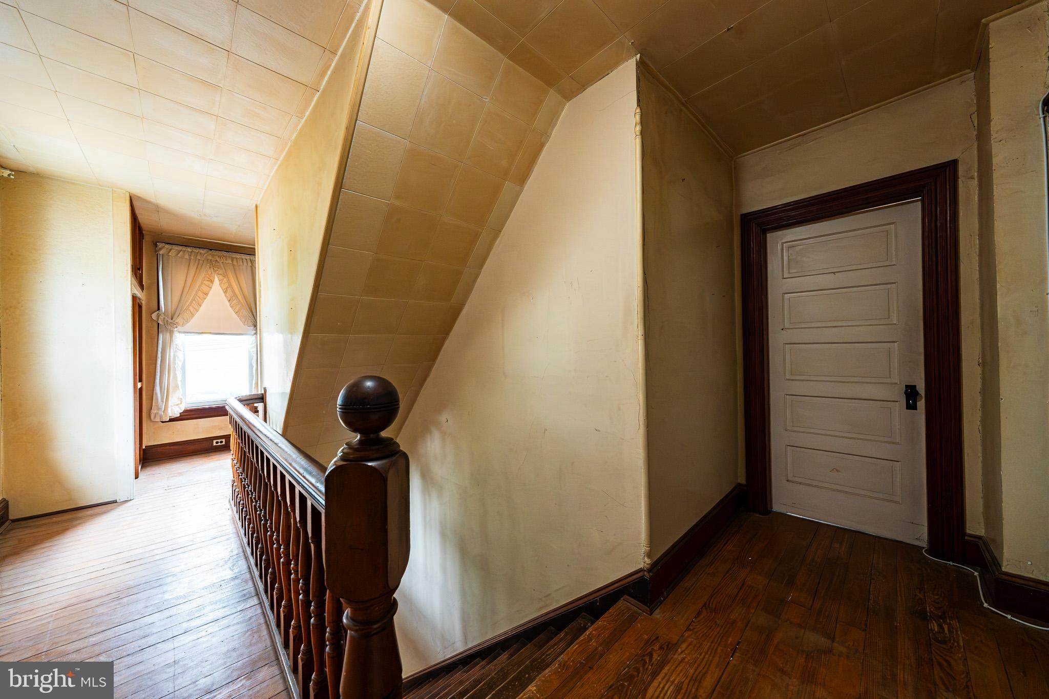 9 Church Lane Baltimore, MD 21208 - Photo 27 of 31 a view of a hallway with wooden floor and staircase