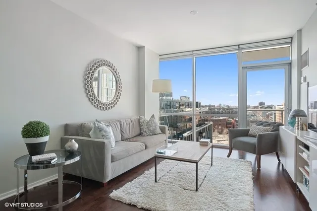 a living room with furniture a rug and a window