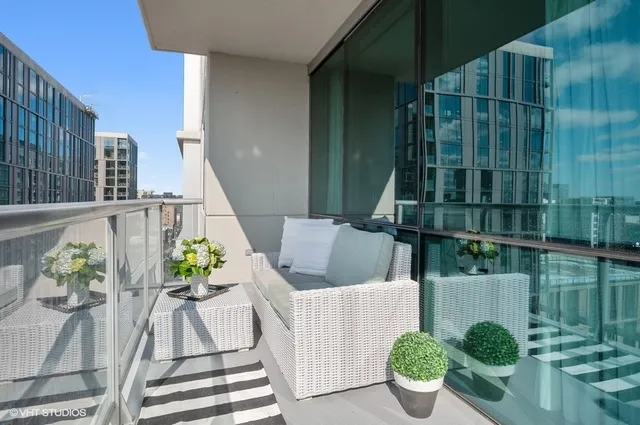 a view of balcony with furniture and potted plants