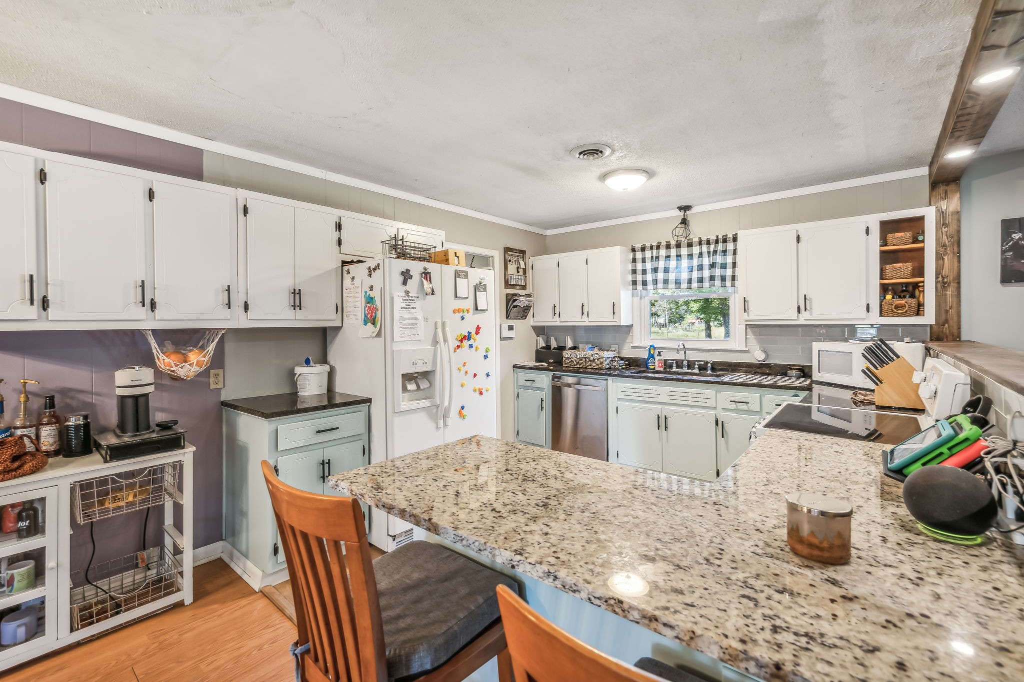 3016 Pocahontas Road Morrison, TN 37357 - Photo 8 of 47 a kitchen with a refrigerator and white cabinets
