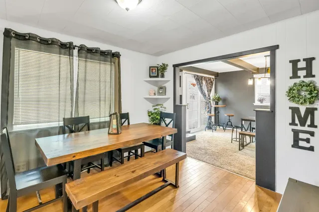 a dining room with furniture and wooden floor