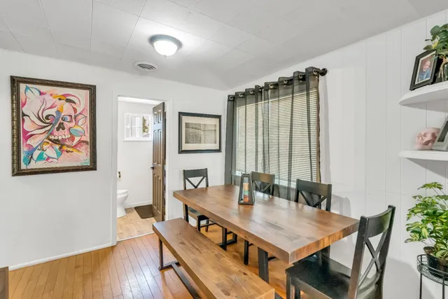 a living room with furniture a flat screen tv and gym equipment