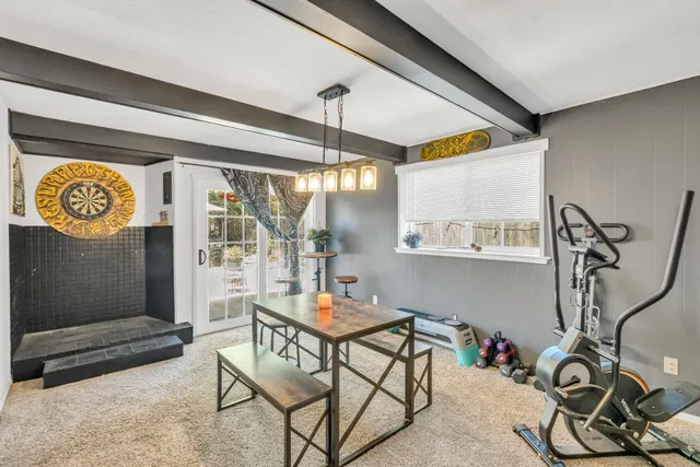 a living room with furniture and paintings on the wall