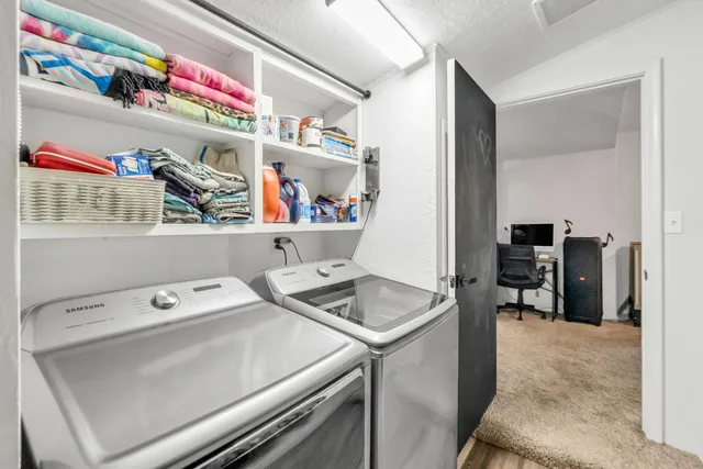 a bedroom with a bed and teddy bear on the dresser