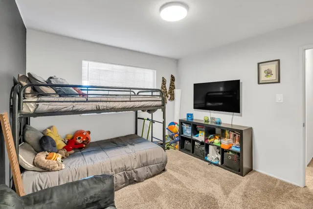 a bedroom with a bed and a flat screen tv