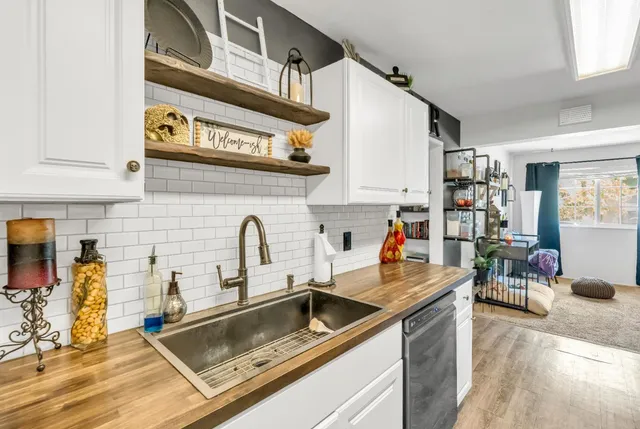 a kitchen with stainless steel appliances granite countertop a sink and cabinets