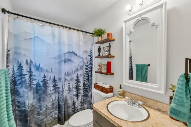 a view of house with backyard and sitting area