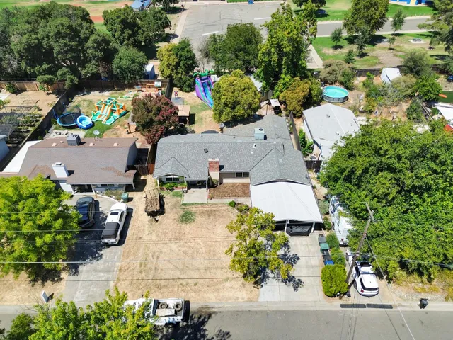 an aerial view of a house with a yard