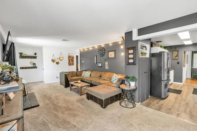 a view of a livingroom with furniture and a flat screen tv