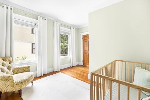 a view of a bedroom with furniture and a window