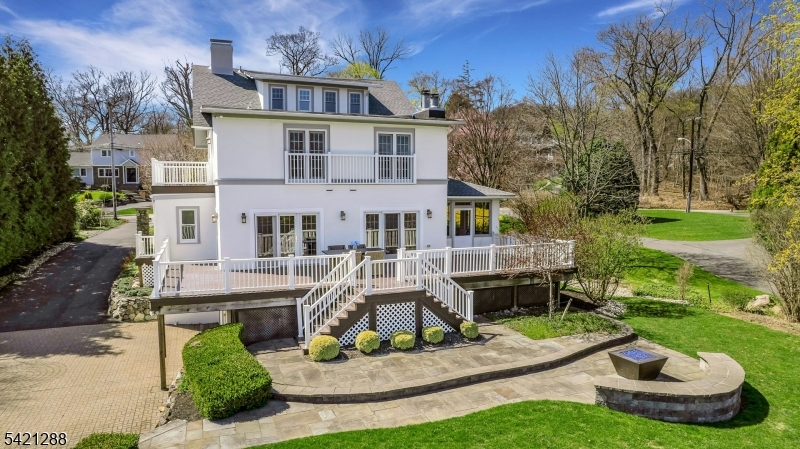 17 Briarcliff Road Mountain Lakes, NJ 07046 - Photo 8 of 50 a front view of a house with a yard table and chairs