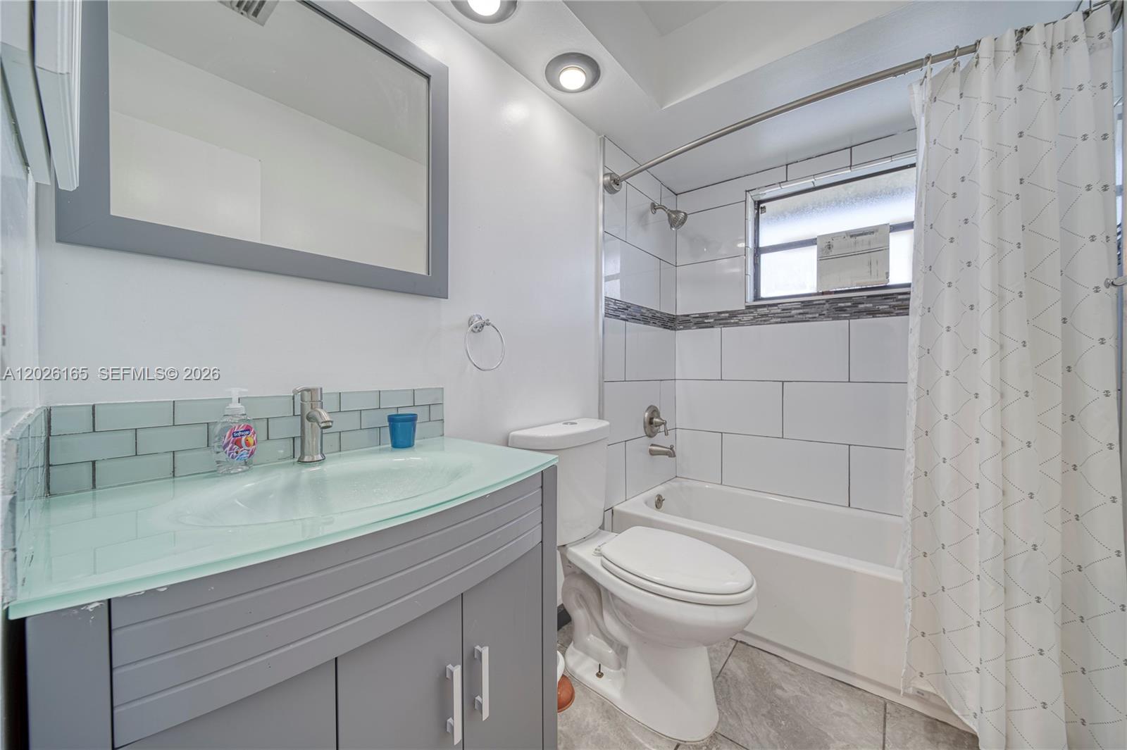 13337 Southwest 64th Lane Miami, FL 33183 - Photo 30 of 36 a bathroom with a sink a toilet and shower
