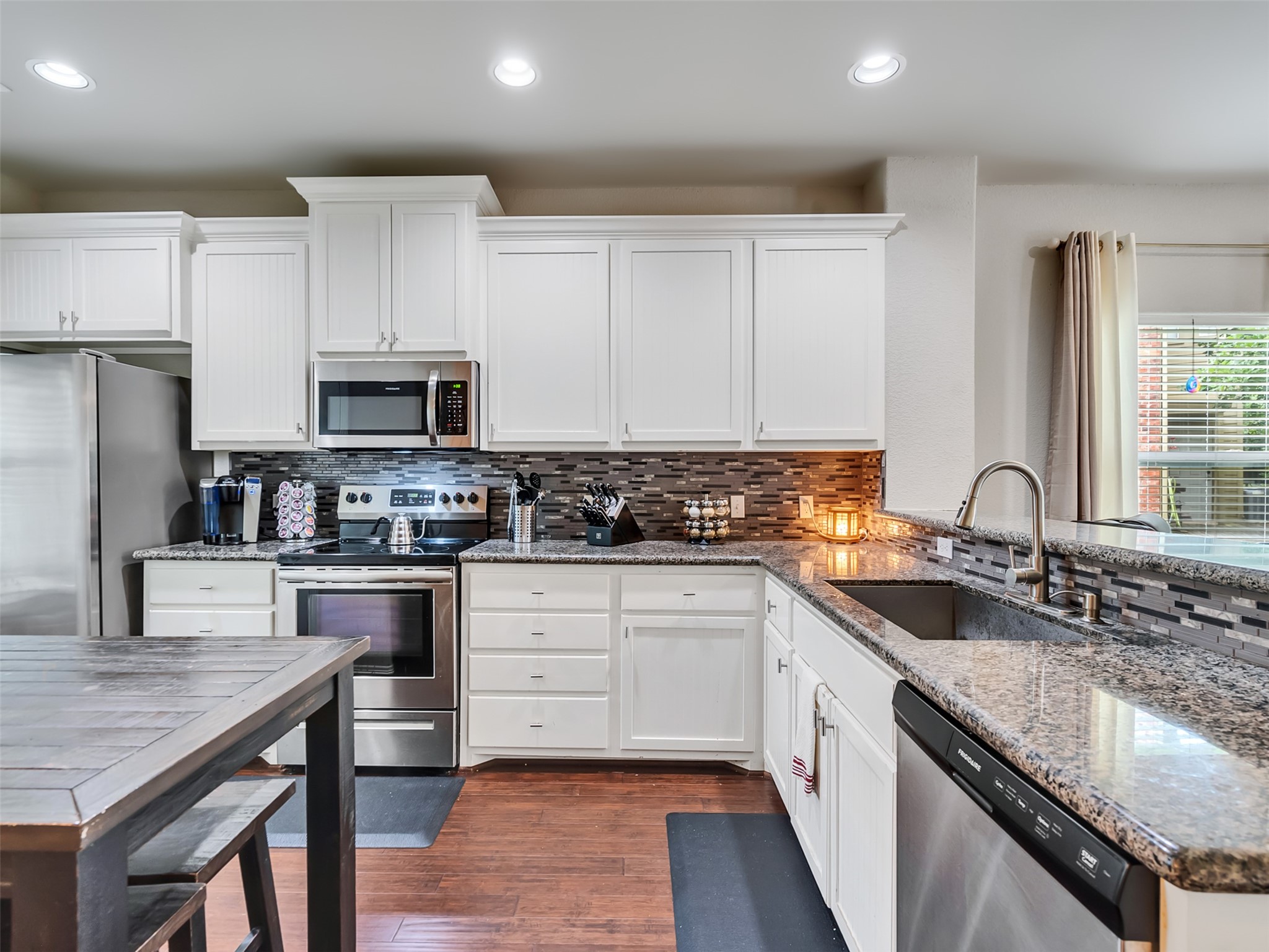 278 Capetown Montgomery, TX 77356 - Photo 11 of 27 a kitchen with stainless steel appliances granite countertop a sink stove microwave and refrigerator