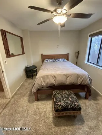 a bedroom with a bed and a tv on the dresser