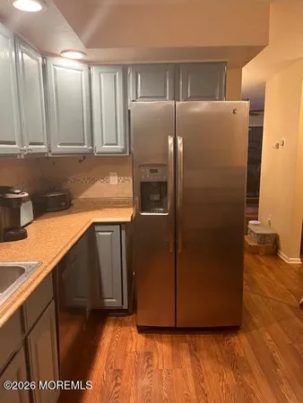 a kitchen with stainless steel appliances granite countertop a refrigerator and a sink