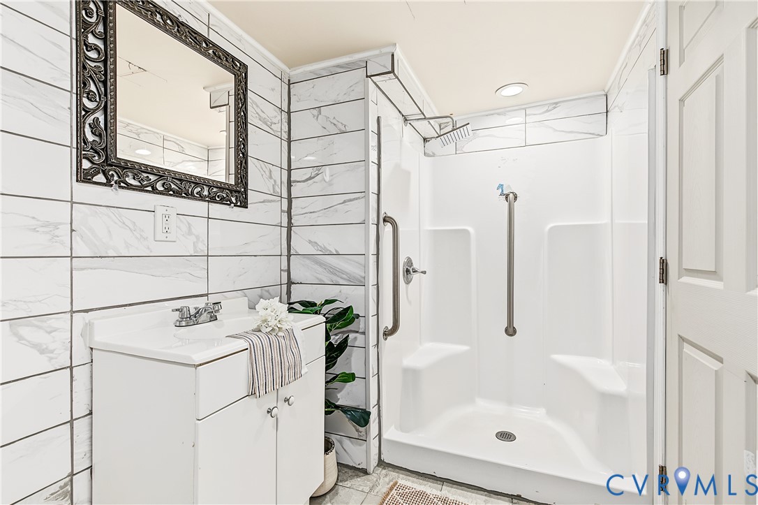 13310 Gladehill Road Chester, VA 23831 - Photo 33 of 41 White tiled walls with a decorative mirror, white
