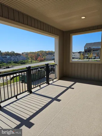 a terrace with a wooden floor and a floor to ceiling window