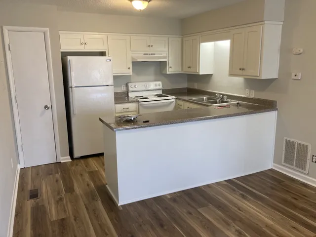 a kitchen with a sink stove and refrigerator