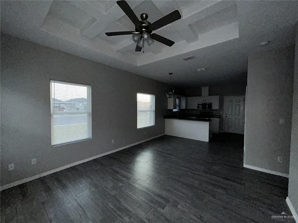 1905 Stauffer Street, Unit 4 Weslaco, TX 78596 - Photo 12 of 13 an empty room with wooden floor and a ceiling fan