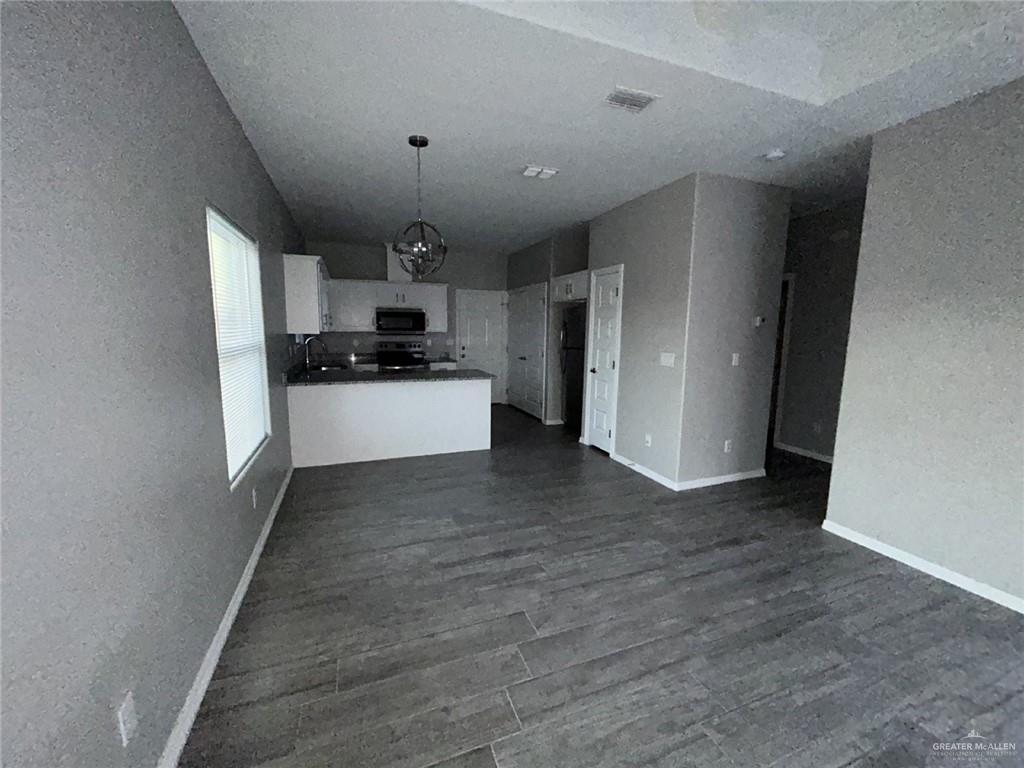 1905 Stauffer Street, Unit 4 Weslaco, TX 78596 - Photo 13 of 13 a view of a kitchen with a sink and a refrigerator