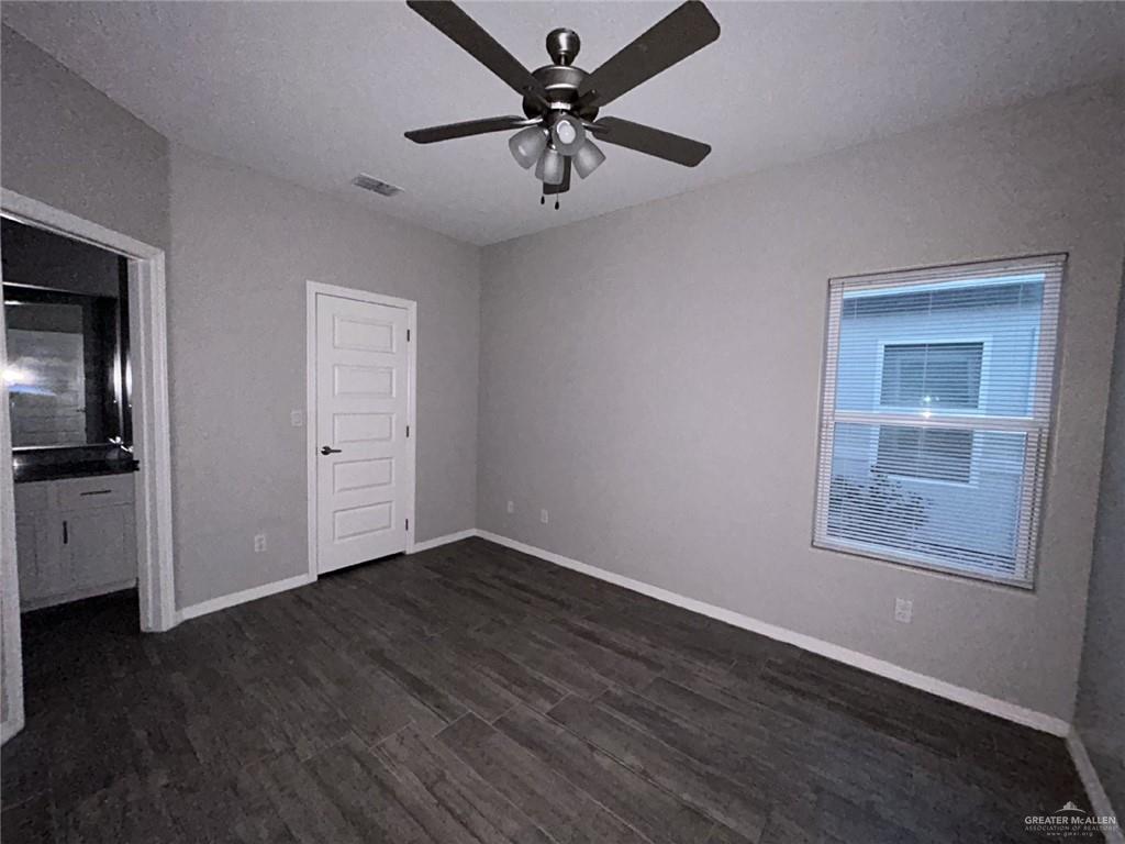 1905 Stauffer Street, Unit 4 Weslaco, TX 78596 - Photo 5 of 13 a view of an empty room with a window and wooden floor