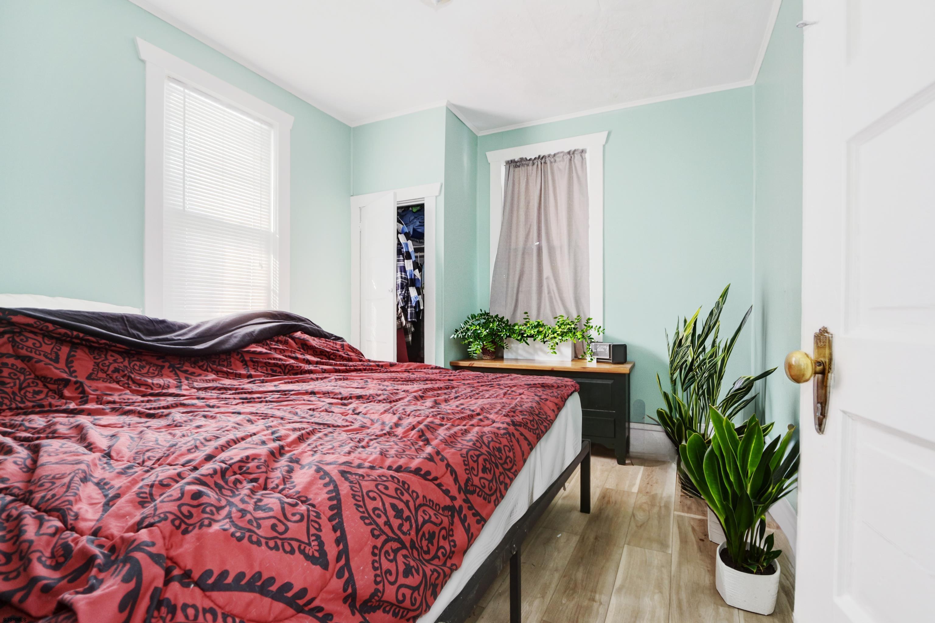215 West Connecticut Avenue Somers Point, NJ 08244 - Photo 14 of 35 a bedroom with a bed and a potted plant