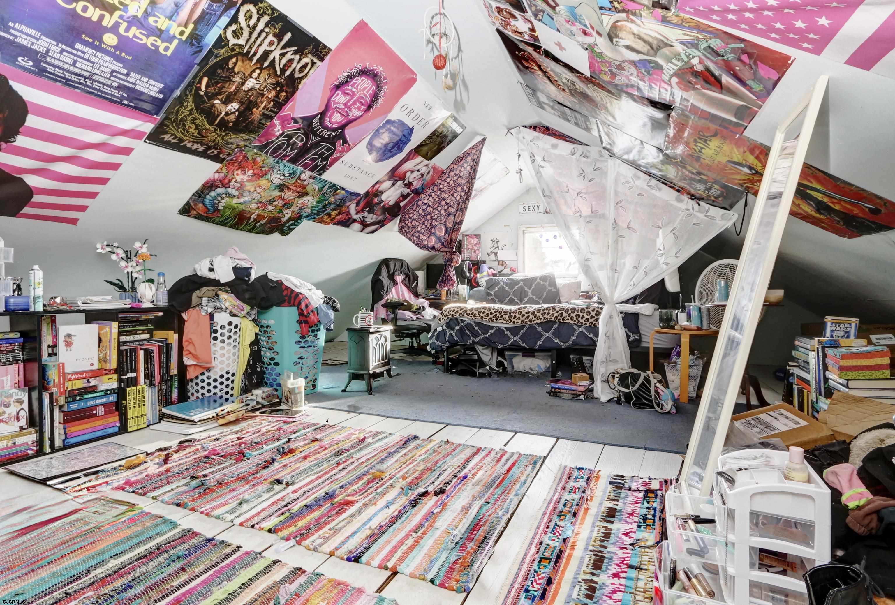 215 West Connecticut Avenue Somers Point, NJ 08244 - Photo 18 of 35 a bed room with a bed and a book shelf