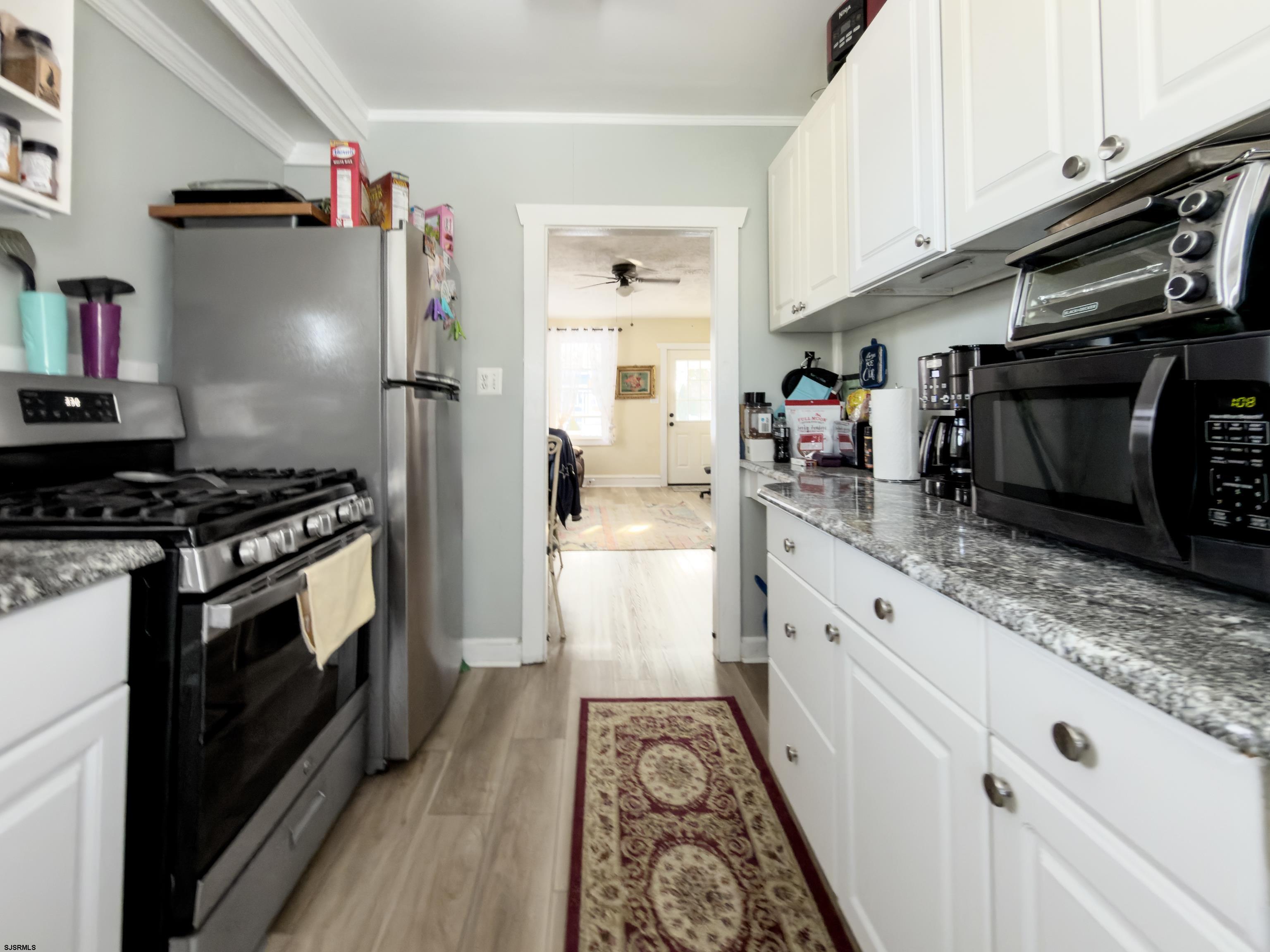 215 West Connecticut Avenue Somers Point, NJ 08244 - Photo 2 of 35 a kitchen with stainless steel appliances a refrigerator a stove and white cabinets