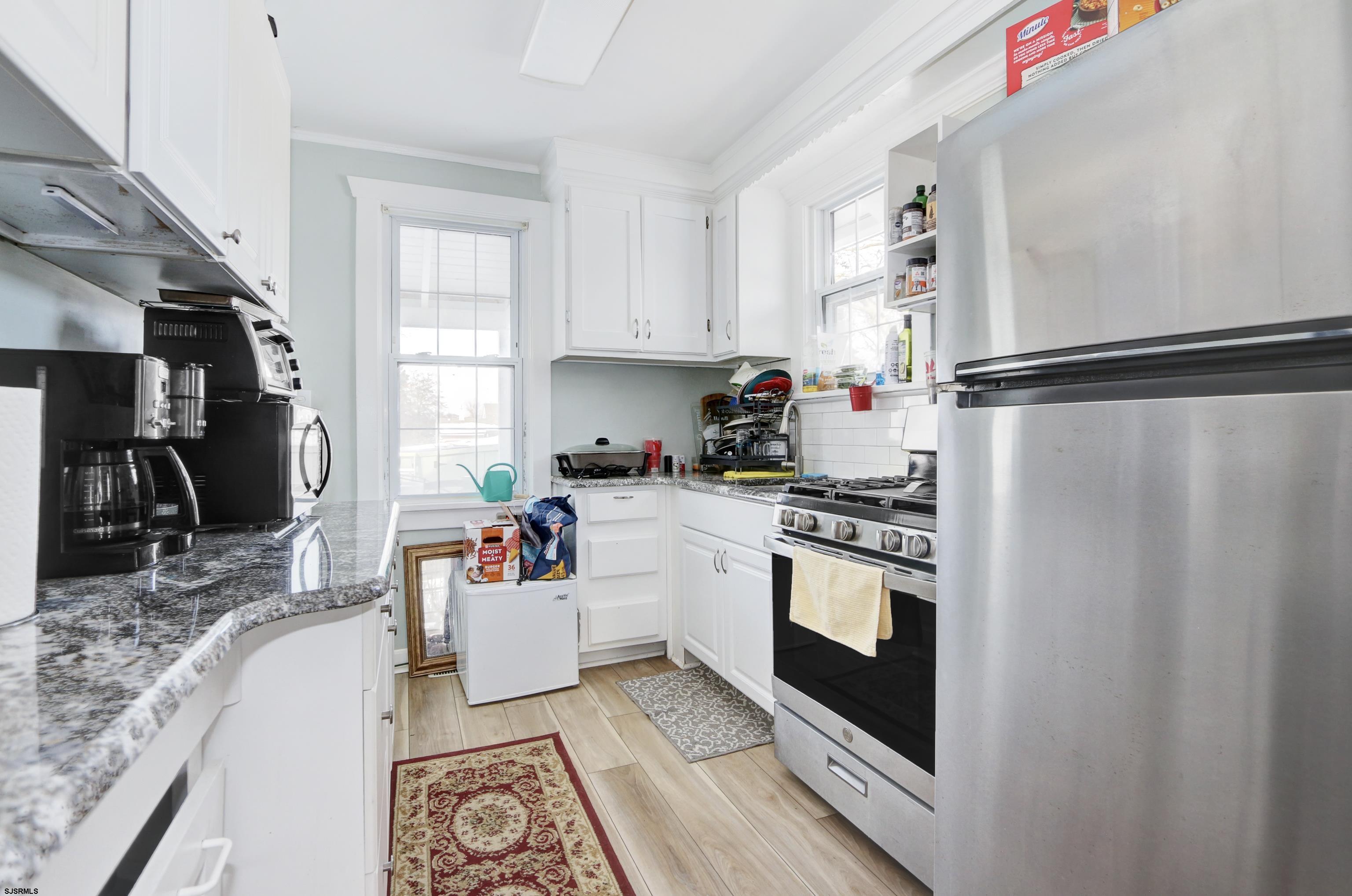 215 West Connecticut Avenue Somers Point, NJ 08244 - Photo 6 of 35 a kitchen with stainless steel appliances granite countertop a refrigerator and a sink