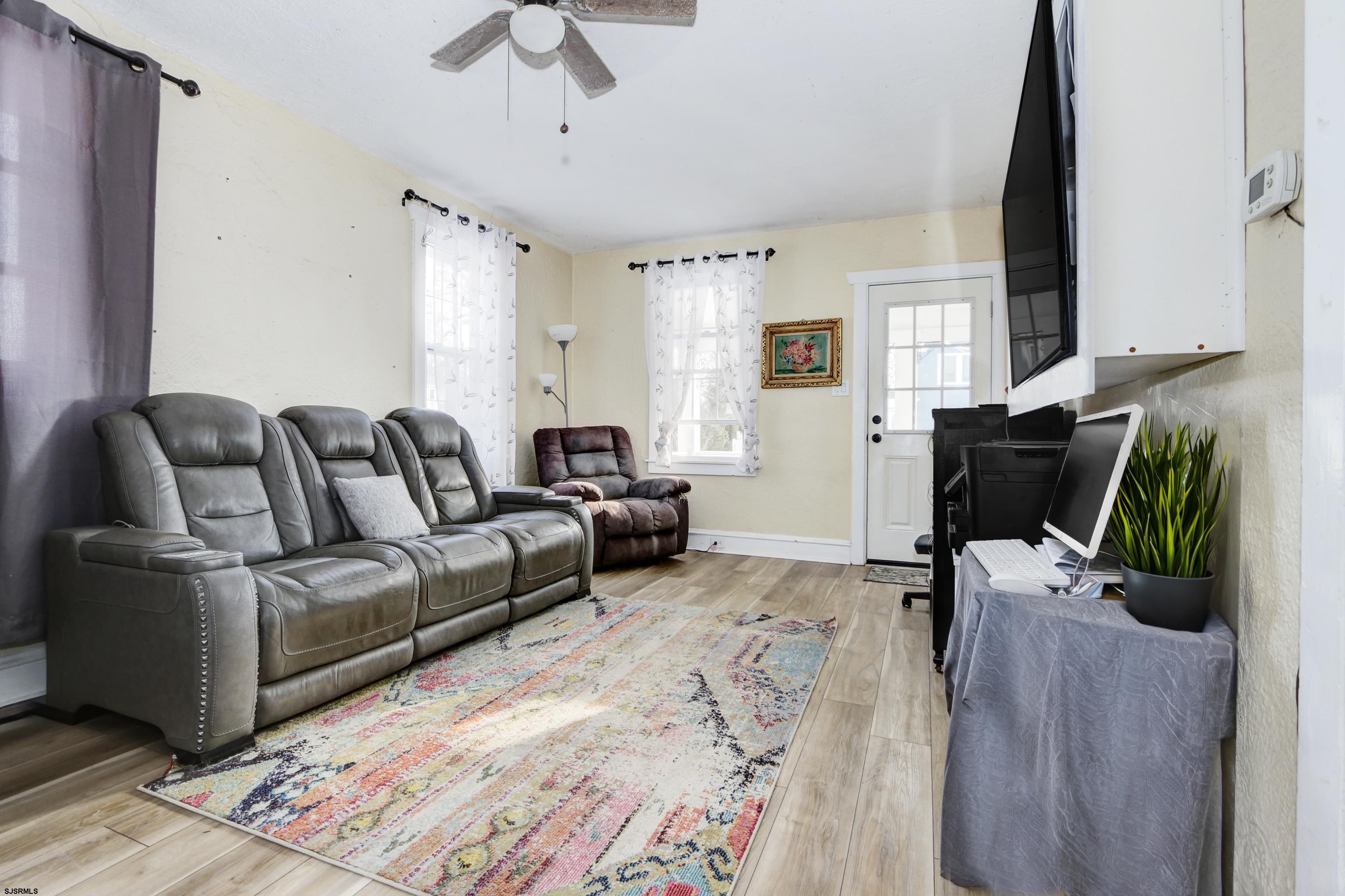 215 West Connecticut Avenue Somers Point, NJ 08244 - Photo 7 of 35 a living room with furniture a couch and a chandelier