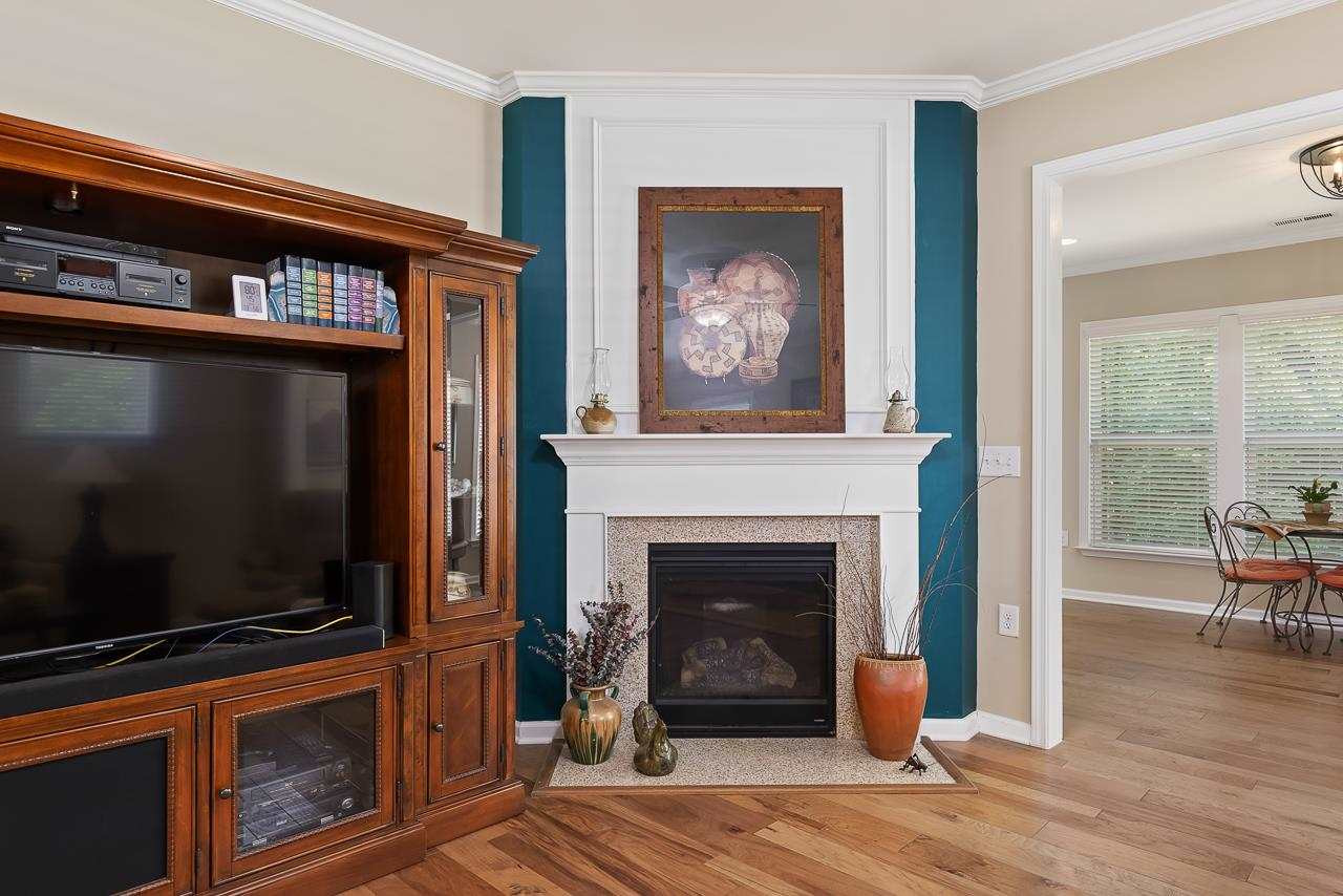 613 Tuttle Road Durham, NC 27703 - Photo 6 of 30 Natural gas fireplace in family room leading to sunroom. Family room