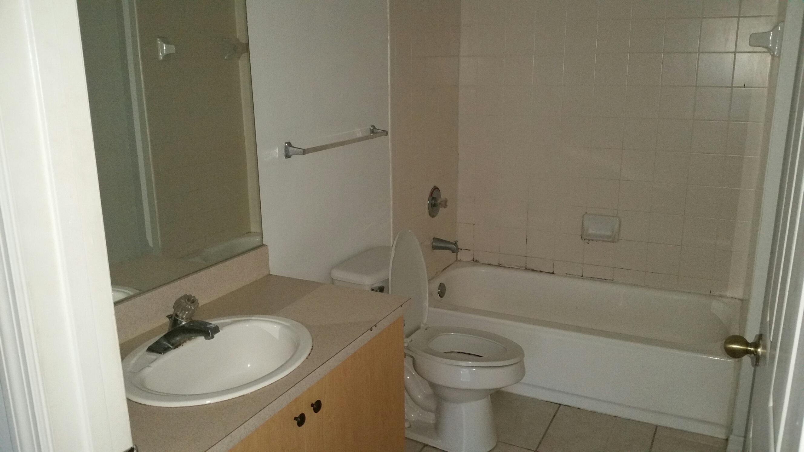 5064 Lantana Road, Unit 6107 Lake Worth, FL 33463 - Photo 13 of 26 a bathroom with a sink and a mirror