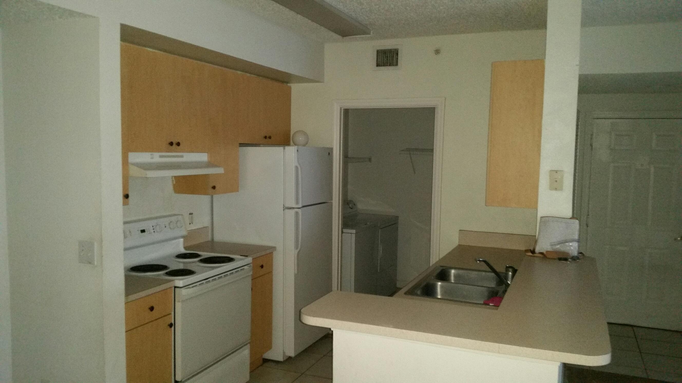 5064 Lantana Road, Unit 6107 Lake Worth, FL 33463 - Photo 17 of 26 a bathroom with a sink and a refrigerator
