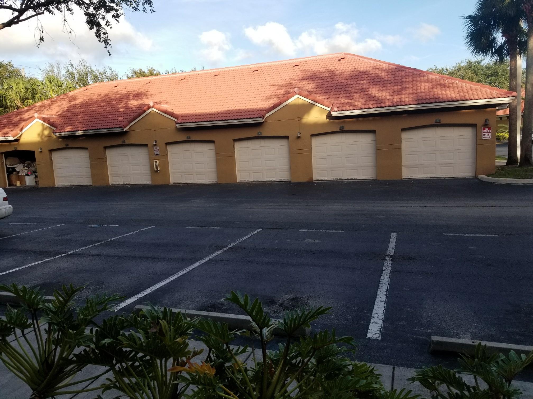5064 Lantana Road, Unit 6107 Lake Worth, FL 33463 - Photo 2 of 26 a front view of a house with a garage