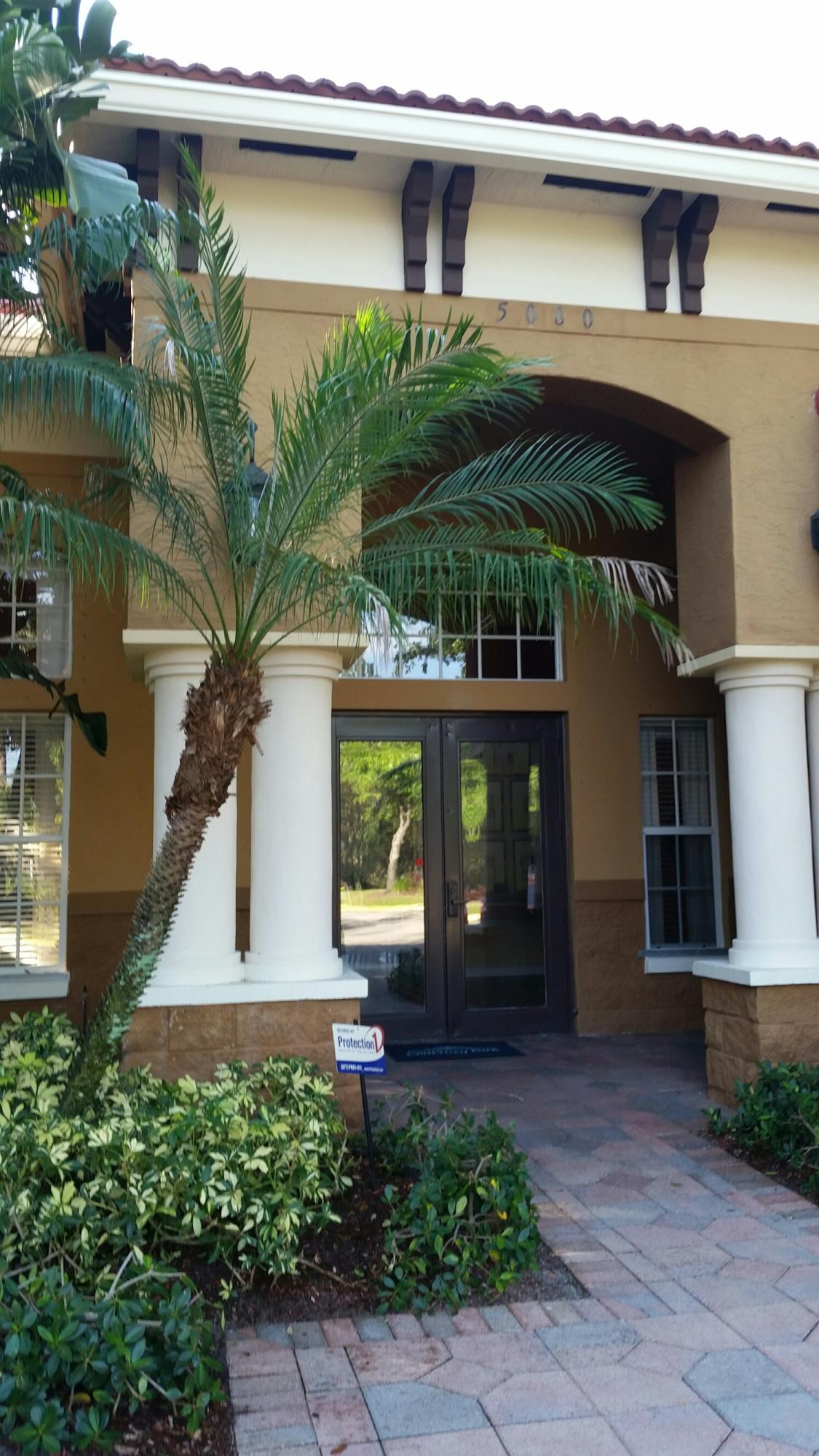 5064 Lantana Road, Unit 6107 Lake Worth, FL 33463 - Photo 25 of 26 a front view of a house with a yard
