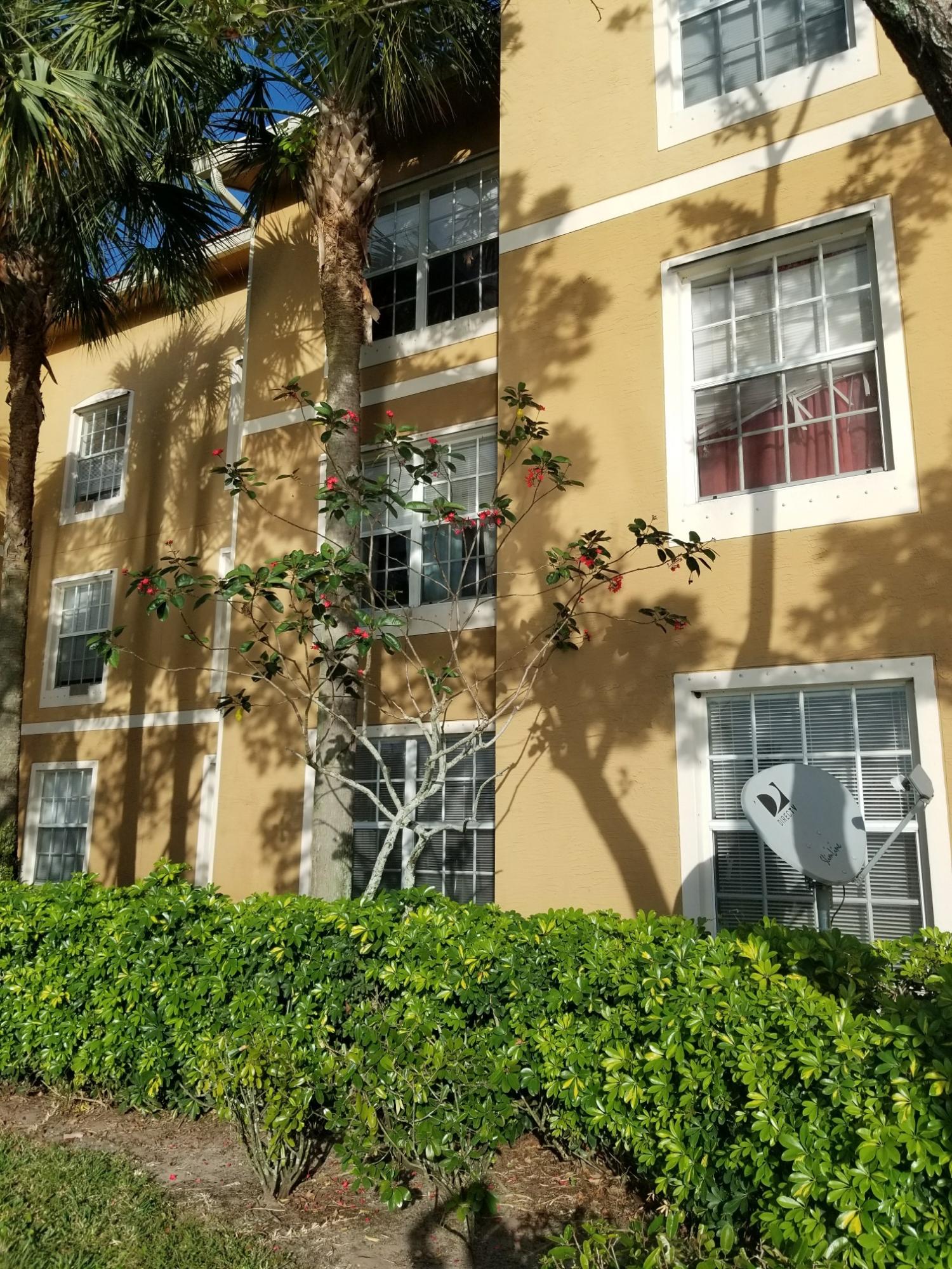 5064 Lantana Road, Unit 6107 Lake Worth, FL 33463 - Photo 4 of 26 aerial view of a brick building next to a yard