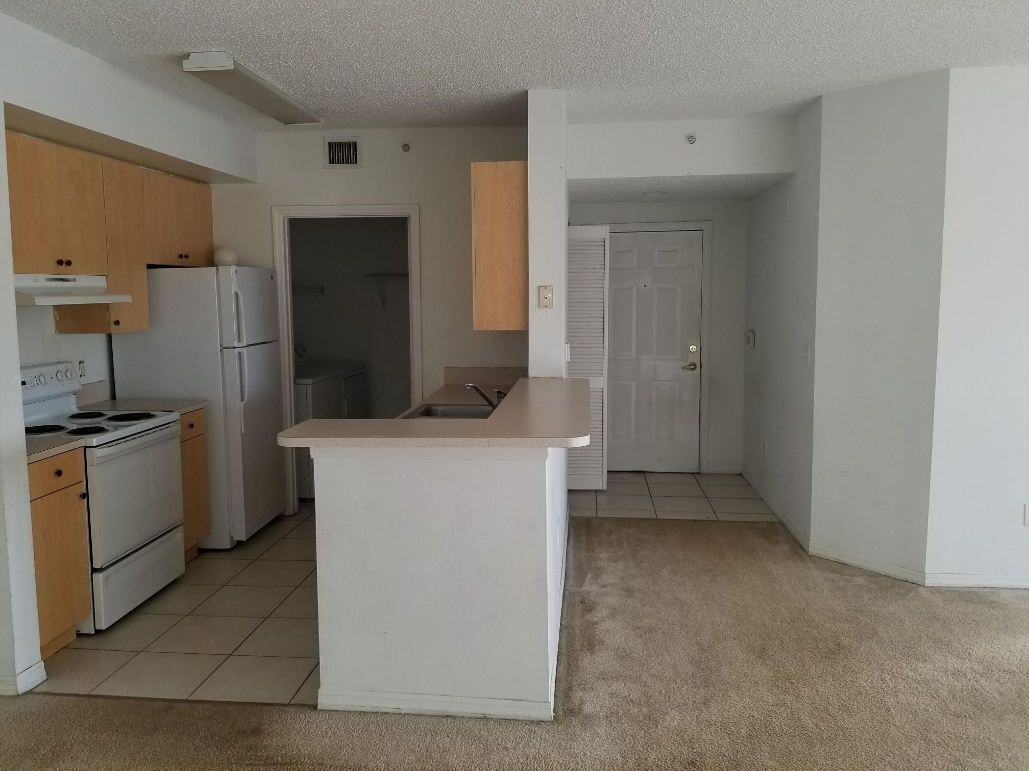 5064 Lantana Road, Unit 6107 Lake Worth, FL 33463 - Photo 7 of 26 a kitchen with cabinets and refrigerator